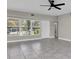 Bright living area boasts tile floors, fresh paint, and natural light from large windows at 10426 109Th St, Seminole, FL 33778