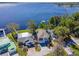 Stunning aerial view of lakefront home with lush landscaping and private dock access at 1162 Tookes Rd, Tarpon Springs, FL 34689