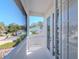 A bright, white balcony with views of neighboring houses and lush greenery, offering a serene outdoor retreat at 1162 Tookes Rd, Tarpon Springs, FL 34689