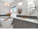 This luxurious bathroom features double sinks, a marble countertop, decorative lighting, and a standalone bathtub at 1162 Tookes Rd, Tarpon Springs, FL 34689