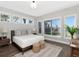 Serene bedroom features many bright windows, clean decor and a view of the lake at 1162 Tookes Rd, Tarpon Springs, FL 34689