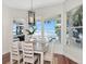 Bright dining room with lake views and a modern light fixture at 1162 Tookes Rd, Tarpon Springs, FL 34689
