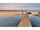 Wooden dock extending into the tranquil water, perfect for boating and enjoying waterfront living at 1162 Tookes Rd, Tarpon Springs, FL 34689