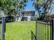 Spacious two-story home with a screened porch and a lush green lawn, perfect for Gathering living at 1162 Tookes Rd, Tarpon Springs, FL 34689