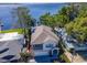 Charming two-story home with a balcony, attached garage, and blue shutters near the water at 1162 Tookes Rd, Tarpon Springs, FL 34689