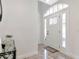 Bright foyer featuring a decorative glass front door and tile flooring at 1162 Tookes Rd, Tarpon Springs, FL 34689