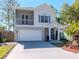 Inviting front exterior with an attached garage, well-manicured lawn, and blue door at 1162 Tookes Rd, Tarpon Springs, FL 34689