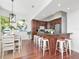 Open kitchen with an island bar, wood cabinets, stainless steel appliances, and modern stools at 1162 Tookes Rd, Tarpon Springs, FL 34689