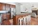 Kitchen with stainless steel refrigerator, bar, stools, and open to the living room at 1162 Tookes Rd, Tarpon Springs, FL 34689