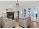 Cozy living room featuring a fireplace, comfortable seating, and French doors leading to an outdoor space at 1162 Tookes Rd, Tarpon Springs, FL 34689