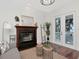 Bright open living room with fireplace, white walls, with french doors opening to an outdoor space at 1162 Tookes Rd, Tarpon Springs, FL 34689