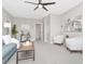 Bright open living room with white walls, grey sofa, lots of natural light, and view of the lake at 1162 Tookes Rd, Tarpon Springs, FL 34689