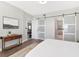 Bright main bedroom features a modern barn door to ensuite bathroom and an open doorway to the home's common area at 1162 Tookes Rd, Tarpon Springs, FL 34689