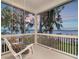 Relaxing covered porch with swing, overlooking the beautiful water view at sunset at 1162 Tookes Rd, Tarpon Springs, FL 34689