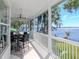 Spacious porch features lake views and outdoor dining at 1162 Tookes Rd, Tarpon Springs, FL 34689