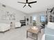 Spacious recreation room with white chairs, gray walls, exercise equipment, and a view of the water at 1162 Tookes Rd, Tarpon Springs, FL 34689