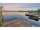 Beautiful dock at sunset offering waterfront leisure with space for a boat and ladder for swimming at 1162 Tookes Rd, Tarpon Springs, FL 34689