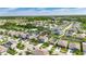 A serene aerial view highlights the property and its beautifully maintained lawn in a friendly neighborhood at 11828 Miracle Mile Dr, Riverview, FL 33578