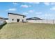 Expansive backyard featuring a spacious lawn and a white fence for privacy at 11828 Miracle Mile Dr, Riverview, FL 33578