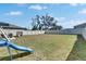 Spacious backyard with lush grass, a playset, and a white fence, creating a Gathering-friendly outdoor space at 11828 Miracle Mile Dr, Riverview, FL 33578
