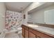 Bathroom featuring a granite vanity, sink and a floral patterned shower curtain at 11828 Miracle Mile Dr, Riverview, FL 33578