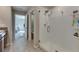 Updated bathroom with a glass-enclosed shower and neutral tile flooring at 11828 Miracle Mile Dr, Riverview, FL 33578