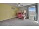 bedroom showcasing a wooden bunk bed, soft carpet, and bright yellow wall at 11828 Miracle Mile Dr, Riverview, FL 33578