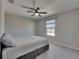 Bright bedroom with light walls, plush carpet, and ceiling fan at 11828 Miracle Mile Dr, Riverview, FL 33578