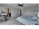 Spacious bedroom with neutral walls, carpet flooring, ceiling fan, and access to an en-suite bathroom at 11828 Miracle Mile Dr, Riverview, FL 33578