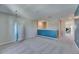 Carpeted bonus room with a light fixture and blue accent wall at 11828 Miracle Mile Dr, Riverview, FL 33578