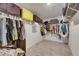 Walk-in closet featuring carpet flooring and custom shelving and racks for maximum storage at 11828 Miracle Mile Dr, Riverview, FL 33578