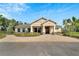 The exterior of the clubhouse shows a covered entryway, and manicured landscaping at 11828 Miracle Mile Dr, Riverview, FL 33578