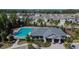 Aerial view of community pool, clubhouse, parking, and manicured landscaping at 11828 Miracle Mile Dr, Riverview, FL 33578