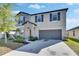 Beautiful two-story home with well-manicured landscaping and attached two-car garage at 11828 Miracle Mile Dr, Riverview, FL 33578