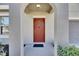 Inviting front entrance features a red door and neutral colored facade at 11828 Miracle Mile Dr, Riverview, FL 33578