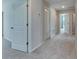 Bright hallway with neutral walls and carpet leads to various rooms in the house at 11828 Miracle Mile Dr, Riverview, FL 33578