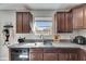 Close-up kitchen view features dark cabinets and granite counters at 11828 Miracle Mile Dr, Riverview, FL 33578