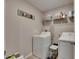 Functional laundry room with a washer, a dryer, shelving, and a 'Laundry' sign at 11828 Miracle Mile Dr, Riverview, FL 33578