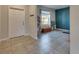Neutral living room with tile floors and a large front door and window at 11828 Miracle Mile Dr, Riverview, FL 33578