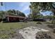 Overgrown backyard with a concrete slab featuring room for customizations and plenty of space for new memories at 15204 Westminister Ave, Clearwater, FL 33760
