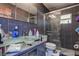 Modern bathroom with a glass bowl sink, walk-in shower, and sleek tile at 15204 Westminister Ave, Clearwater, FL 33760