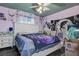 Bedroom features celestial themed ceiling, fan, window, and bed at 15204 Westminister Ave, Clearwater, FL 33760