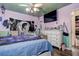 Bedroom features celestial themed ceiling, fan, window, bed, and dresser at 15204 Westminister Ave, Clearwater, FL 33760
