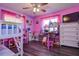 Pink-themed bedroom with bunk bed, toys, and a large window at 15204 Westminister Ave, Clearwater, FL 33760