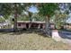 A view of a home's exterior amidst lush trees and yard at 15204 Westminister Ave, Clearwater, FL 33760