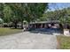 Charming single-story home with a long driveway, complemented by mature trees and well-kept landscaping at 15204 Westminister Ave, Clearwater, FL 33760