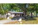A charming single-story home with a long driveway, complemented by mature trees and well-kept landscaping at 15204 Westminister Ave, Clearwater, FL 33760