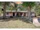 Charming single-story home with mature trees and a well-kept front yard, featuring arched doorways at 15204 Westminister Ave, Clearwater, FL 33760