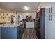 Bright kitchen featuring modern appliances, updated cabinets, an island, and hardwood floors at 15204 Westminister Ave, Clearwater, FL 33760
