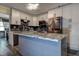 Modern kitchen with island, stainless steel appliances, granite countertops, and ample cabinet space at 15204 Westminister Ave, Clearwater, FL 33760